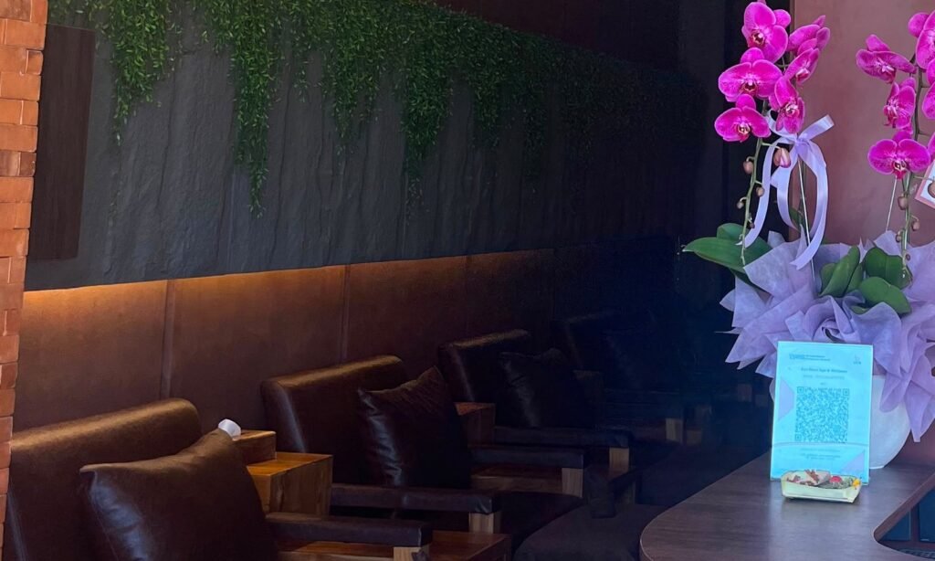 Reflexology recliners and the wall of trailing greenery seen from reception