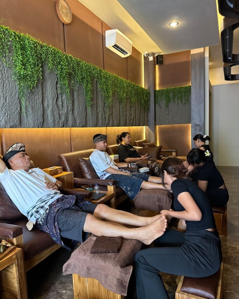 Therapists giving foot and leg massage to guests in the reflexology lounge